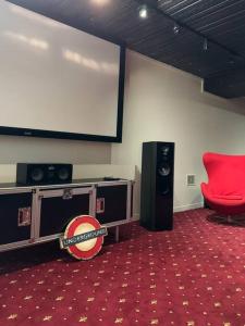 a room with a large screen and a red chair at Luxury stay in Williamstown in Williamstown