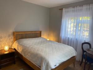 a bedroom with a bed and a window at Victoria's house in Kells