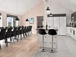 a kitchen and dining room with a bar with black chairs at Holiday home Kappeln XXX in Kappeln