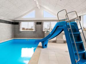 a indoor swimming pool with a slide in a building at Holiday home Kappeln XXX in Kappeln