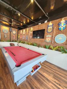 a pool table in a room with a wall with signs at The Upper House resort by J R high Sky in Morjim