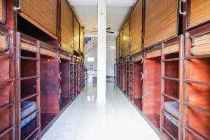 a row of wooden shelves in a hallway at Bali Backpacker Inn & Hostel in Ubud