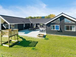 a house with a playground in the yard at Holiday home Kappeln XXVI in Kappeln