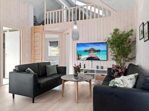 a living room with a couch and a table at Holiday home Kappeln XXVI in Kappeln