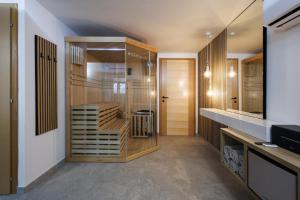a room with a walk in closet with wooden cabinets at Franc Holiday House With a Spacious Terrace, Hot Tub And Sauna in Lopatinec