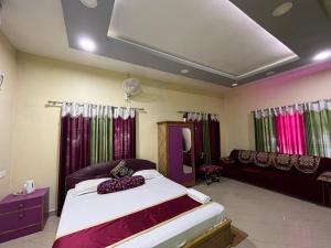 1 dormitorio con 1 cama grande y 1 sofá en Green Reed Homestay, en Kāziranga