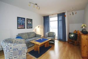 a living room with a couch and a table at Apartment in Boltenhagen near the sea in Boltenhagen