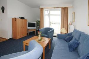 a living room with blue couches and a television at Apartment in Boltenhagen near the sea in Boltenhagen