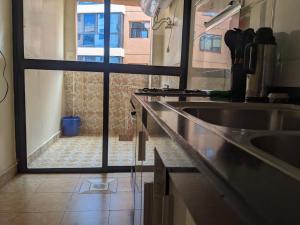 a kitchen with a sink and a view of a window at bliss Haven spaces kileleshwa 2bedroom in Nairobi