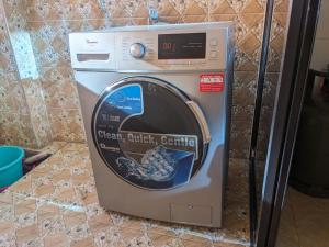 a washing machine sitting on top of a counter at bliss Haven spaces kileleshwa 2bedroom in Nairobi