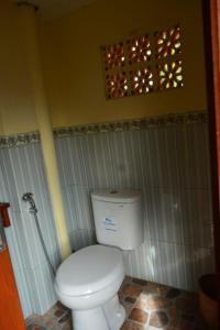 a bathroom with a white toilet in a room at BIG K HOSTEL in Karimunjawa