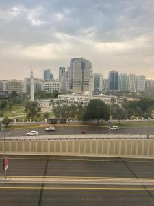 Blick auf eine Stadt mit Autos auf einem Parkplatz in der Unterkunft Heart of Abu Dhabi - Wonder Balcony Room in Abu Dhabi