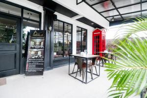 a red phone booth and a table outside a restaurant at RedDoorz Plus @ Jalan Raden Intan Lampung in Bandar Lampung