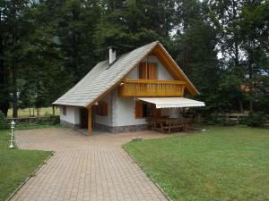 a small house with a porch and a picnic table at Holiday House Kaja in Mojstrana
