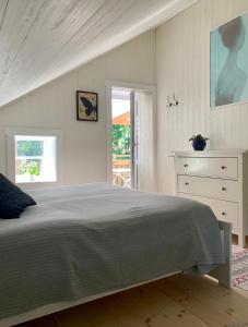 1 dormitorio con 1 cama, vestidor y ventana en Cozy cottage with sea view, en Svenshögen