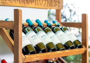 a bunch of wine bottles in a wooden wine rack at The Square Kampot Hotel in Kampot