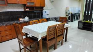 a kitchen with a table and chairs in a kitchen at ZR Homestay in Jitra