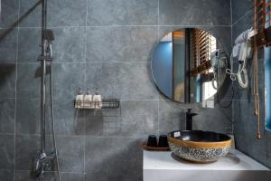 a bathroom with a sink and a mirror at Eva Măng Đen Homestay in Kon Von Kla +60 photos