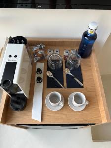 a wooden tray with a coffee maker and cups at Casabell 3 Caminito del Rey in Valle de Abdalagís