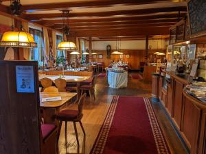 a room with tables and chairs in a store at Hotel Restaurant Albans Sonne in Bad Rippoldsau