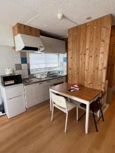 a kitchen with a table and chairs in a room at Rhodes Kagurazaka - Vacation STAY 77350v in Tokyo