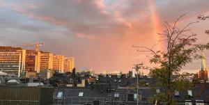 a city skyline with a rainbow in the sky at Stockholm City in Stockholm