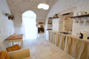 a kitchen with a sink and a counter in a room at Casa Matteotti by Wonderful Italy in Conversano