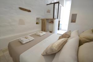 a large white bed with two pillows on it at Casa Matteotti by Wonderful Italy in Conversano