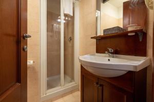 a bathroom with a sink and a shower at Locanda Delle Corse in Rome