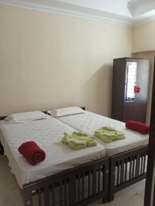 a bed with towels on it in a room at SRI PADMANABHA TOURIST HOME in Chacka