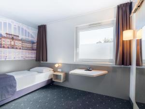 Voodi või voodid majutusasutuse B&B Hotel Mannheim-Neuostheim toas