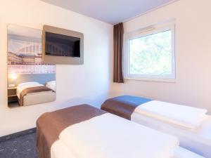 Voodi või voodid majutusasutuse B&B Hotel Mannheim-Neuostheim toas