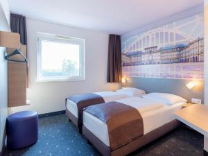 Voodi või voodid majutusasutuse B&B Hotel Mannheim-Neuostheim toas