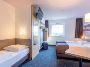 Postel nebo postele na pokoji v ubytování B&B Hotel Mannheim-Neuostheim + 22 fotografií