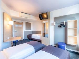 Voodi või voodid majutusasutuse B&B Hotel Mannheim-Neuostheim toas