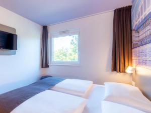 Voodi või voodid majutusasutuse B&B Hotel Mannheim-Neuostheim toas