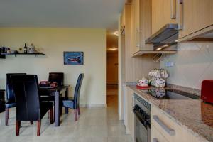 a kitchen with a table and a dining room at Belair Tazacorte in Tazacorte
