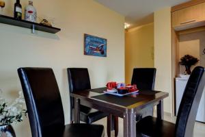 a dining room with a table and chairs at Belair Tazacorte in Tazacorte +9 photos