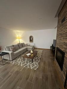 a living room with a couch and a tv at Casa do Gaspar in Ribeira de Pena