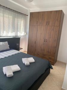 a bedroom with a bed with two towels on it at Luxury Apartment 2 in Alexandroupoli