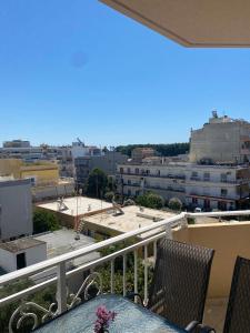 a balcony with chairs and a view of a city at Luxury Apartment 2 in Alexandroupoli