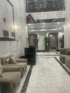 a lobby with couches in a building at نجد العذية in Jarwal