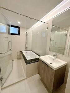 a bathroom with a sink and a shower and a mirror at 2 beds bangkok center max 6 in Klong Toi