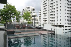 a pool of water with two tall buildings at Circle Rein Sukhumvit 12 two bedrooms apartment in Klong Toi
