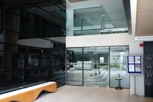 a large glass building with a bench in front of it at 2 beds bangkok center max 6 in Klong Toi
