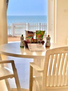 a white table with a view of the ocean at Beach at the White House in Udupi