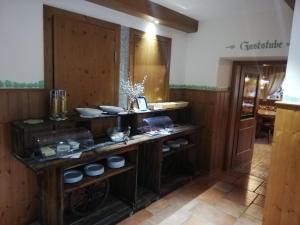 a kitchen with a counter with bowls and dishes at Machlandgasthof Wahl in Ruprechtshofen