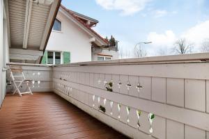 a balcony with a fence with flowers on it at Ferienwohnung Caprano in Sonthofen