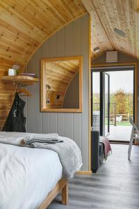 a bedroom with a bed and a wooden ceiling at Little Quarry Glamping Bed and Breakfast in Tonbridge