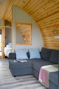 a living room with a couch and a bed at Little Quarry Glamping Bed and Breakfast in Tonbridge